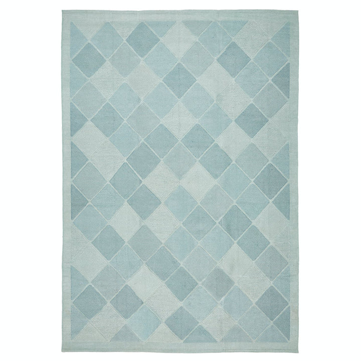 Contemporary diamond-patterned rug in shades of blue creates a calming atmosphere.