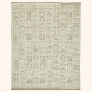Rectangular rug with geometric pattern in monochromatic beige tones.