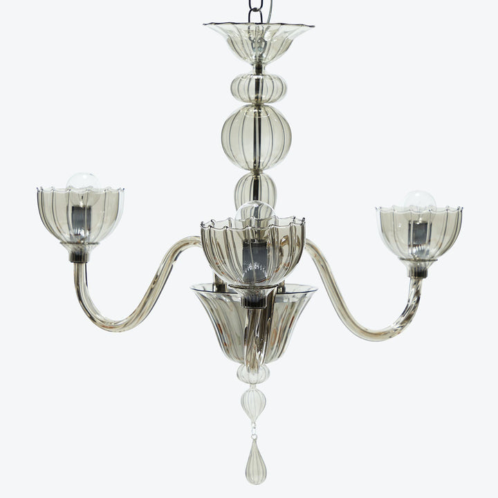 Elegant chandelier with stacked glass elements and metallic framework.