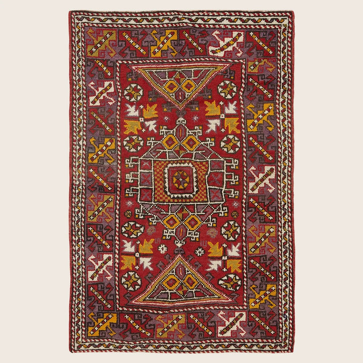 Traditional handmade rug with intricate geometric design and rich color.
