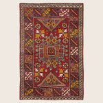 Traditional handmade rug with intricate geometric design and rich color.