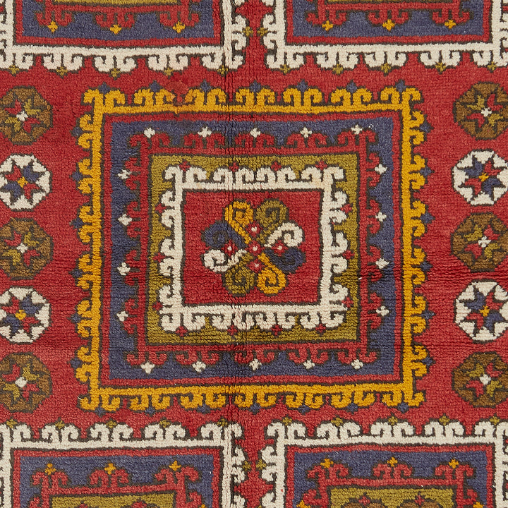 Intricate and symmetrical patterned carpet showcases rich traditional colors.