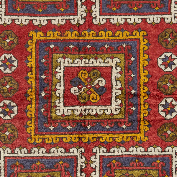 Intricate and symmetrical patterned carpet showcases rich traditional colors.