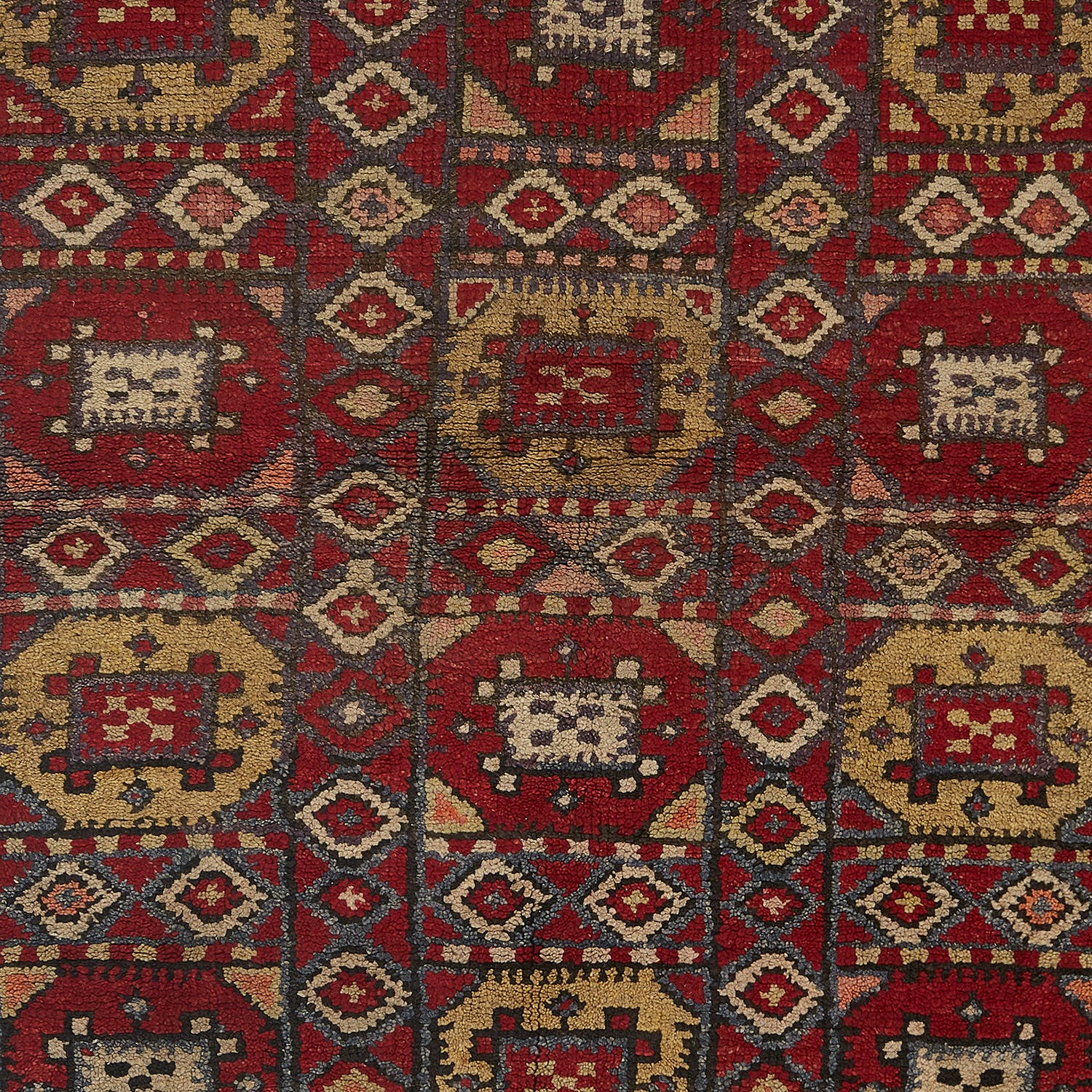 Richly patterned hand-woven rug with traditional motifs from a cultural region.