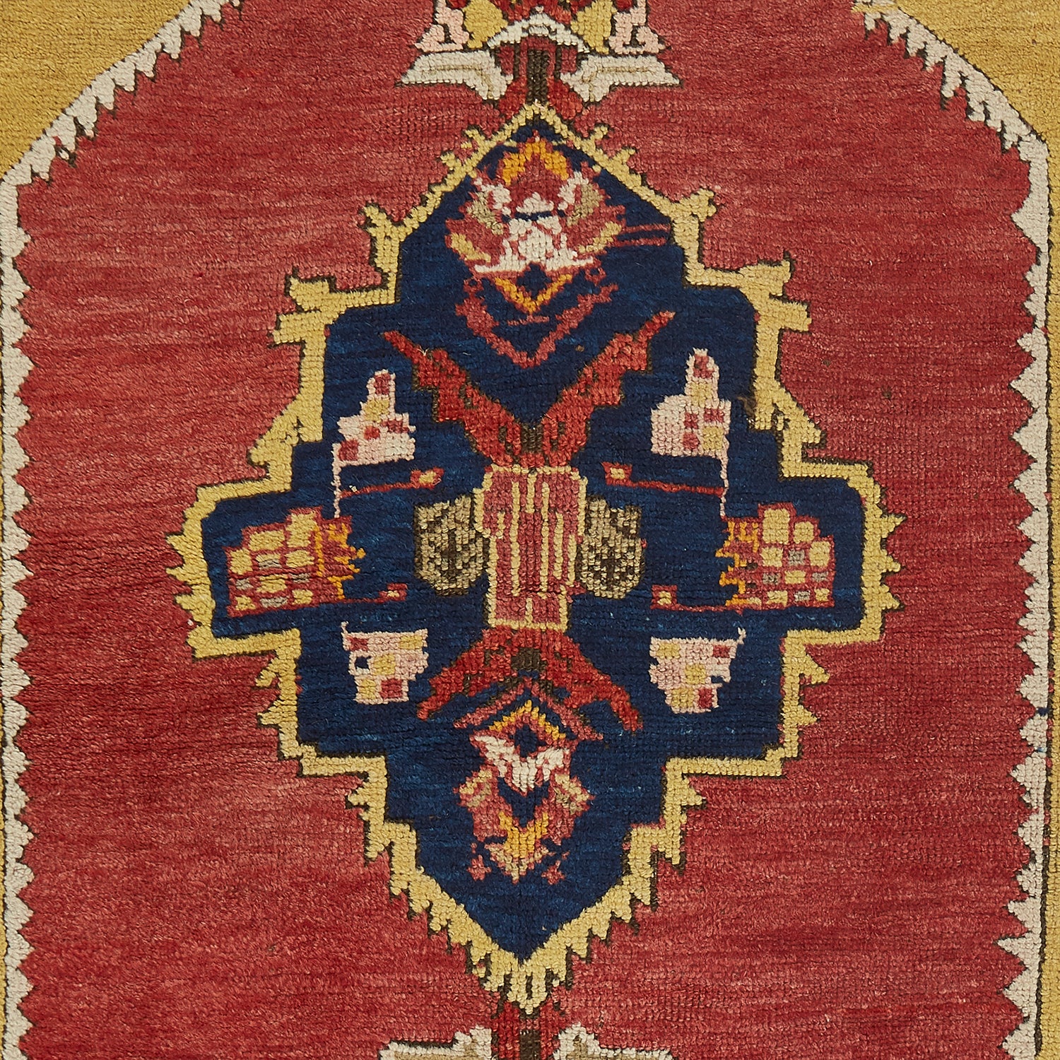 Intricately patterned handwoven rug showcases a symmetrical oriental design.