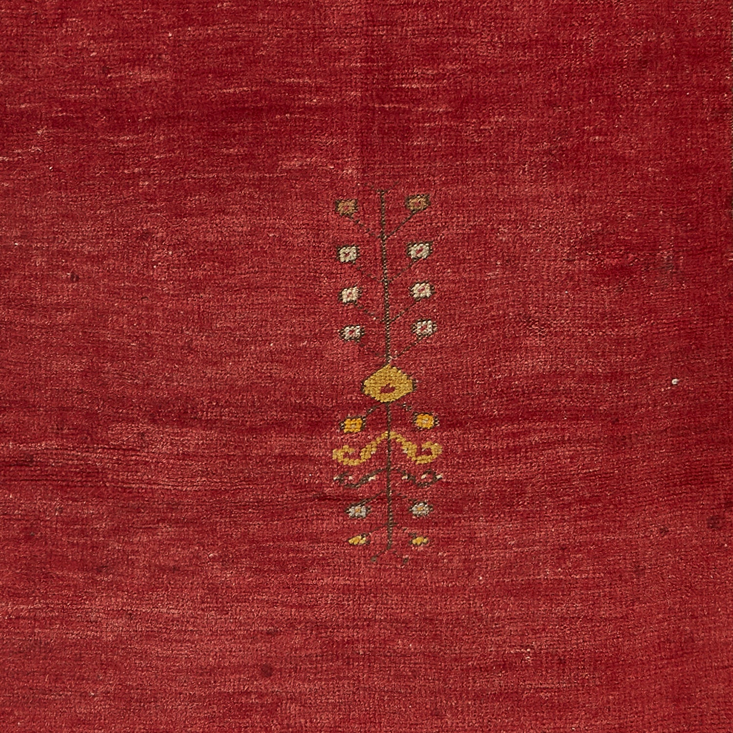 Handcrafted ethnic textile featuring a red background with contrasting motifs
