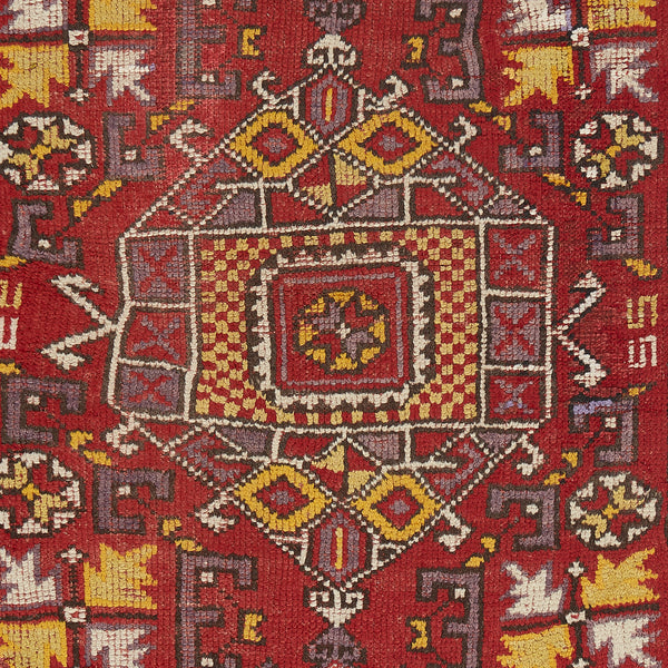 Intricate and symmetrical Oriental rug showcasing rich red color and geometric motifs.