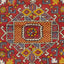 Vibrant, symmetrical carpet displays intricate geometric patterns in rich colors.