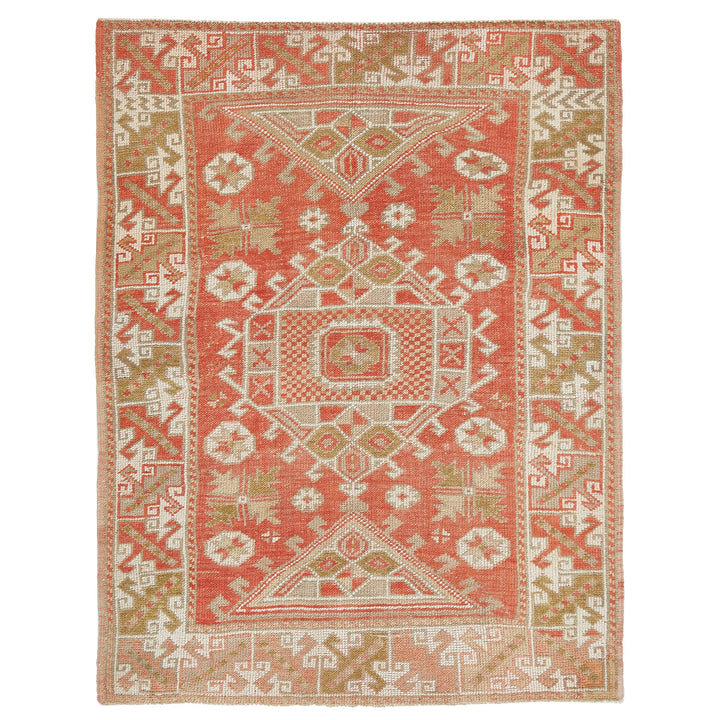 Intricate traditional rug with geometric patterns in coral and beige.