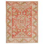 Intricate traditional rug with geometric patterns in coral and beige.