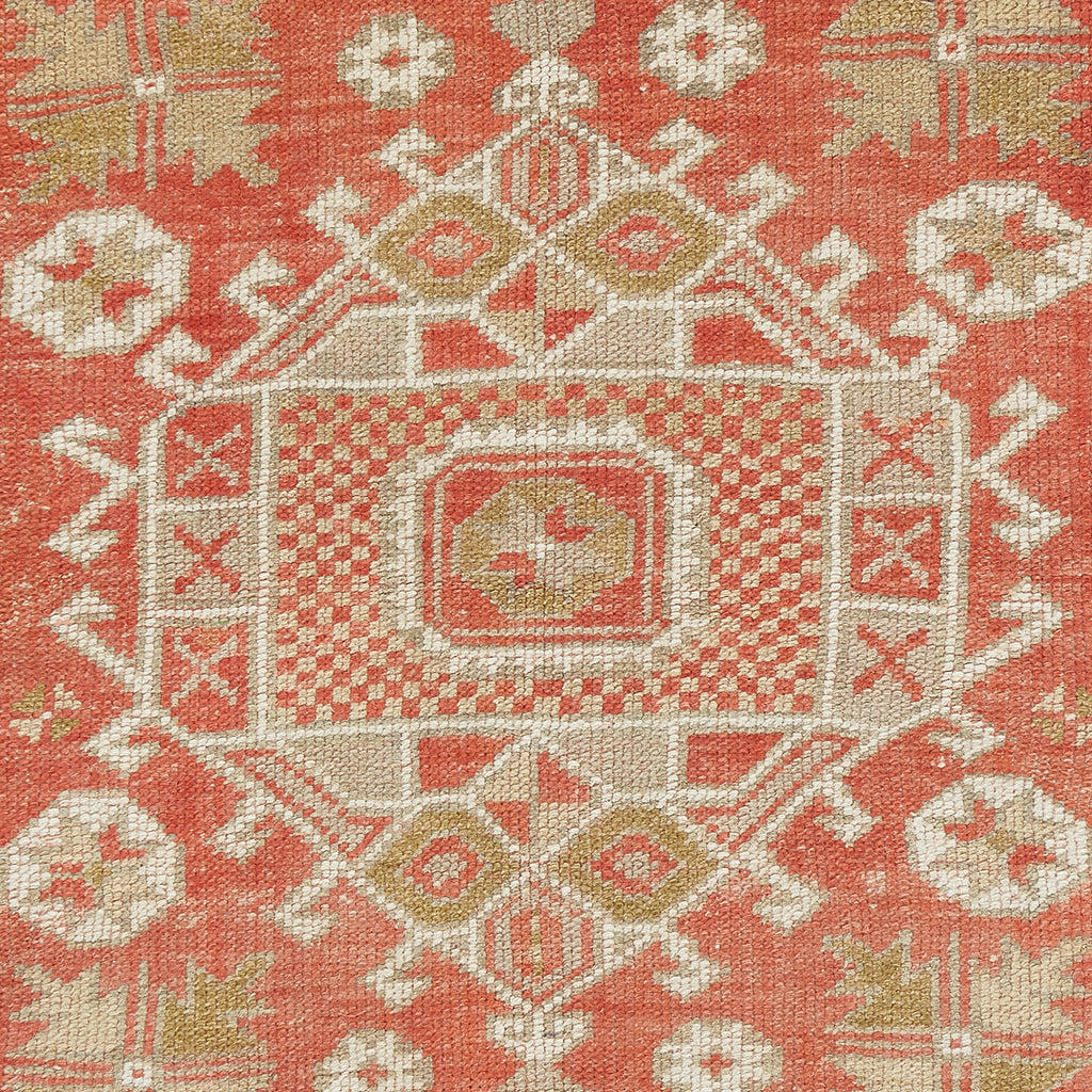 Handwoven fabric with intricate geometric and abstract patterns in warm tones.