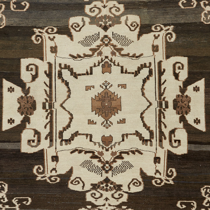 Intricate symmetrical rug with geometric and floral motifs, neutral tones.