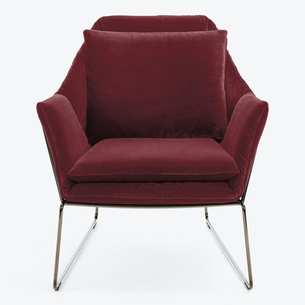 Contemporary single-seat armchair with plush red velvet upholstery and sleek metal frame