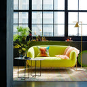 A modern urban living space with vibrant lime green sofa.