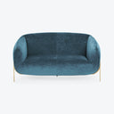 Contemporary teal velvet sofa with curved design and golden legs.