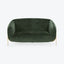 Modern sofa with curved backrest and dark green velvet upholstery.