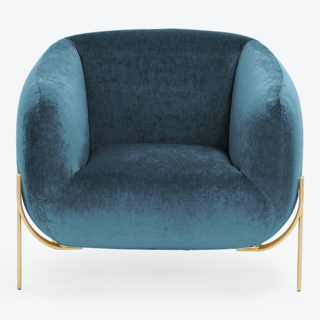 Modern-style armchair in deep teal upholstery with gold metal legs.
