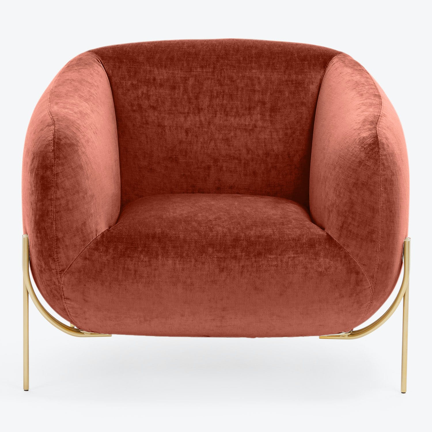 Modern armchair with curved silhouette and plush dusty rose upholstery.
