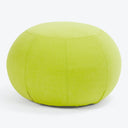 Vibrant lime green round cushion adds a pop of color.