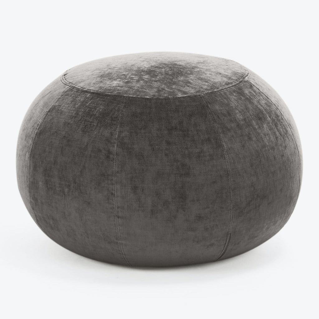 Modern grey velvet pouf with versatile functionality for contemporary interiors.