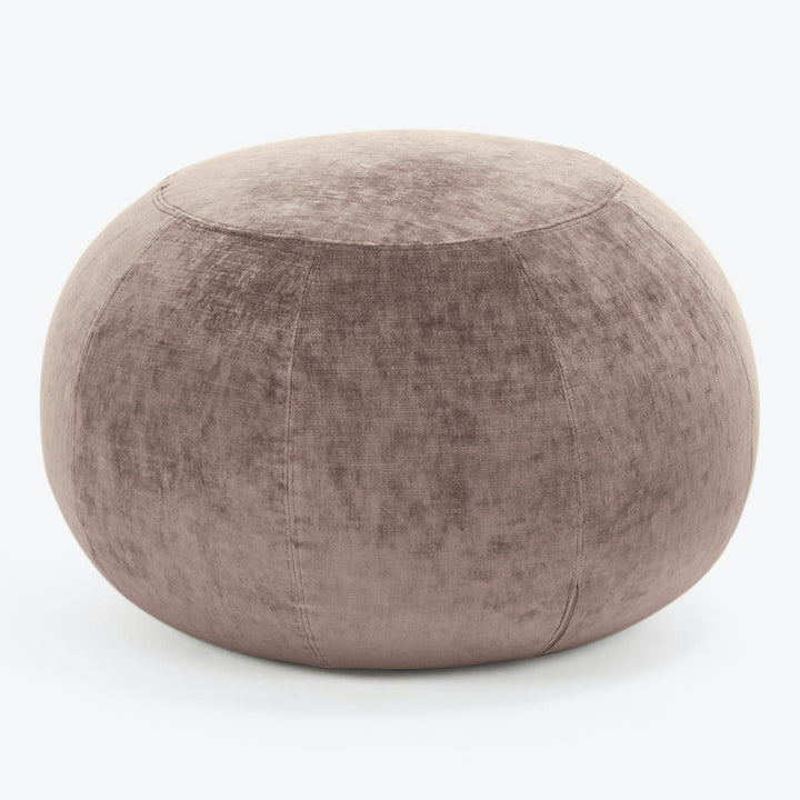 Velvety mauve ottoman adds a touch of elegance to any space