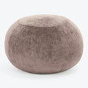 Velvety mauve ottoman adds a touch of elegance to any space