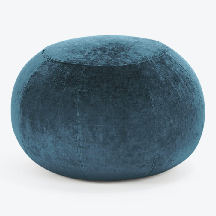 Teal velvet pouf, a stylish and versatile home decor item.