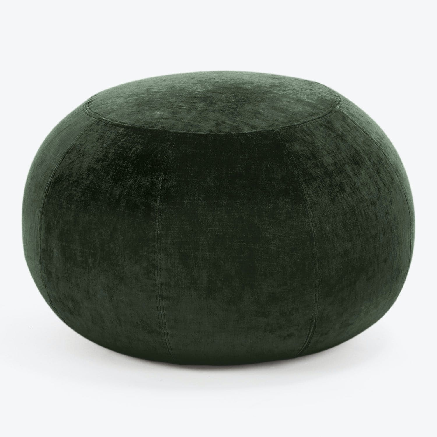 Dark green velvet ottoman adds a touch of elegance.
