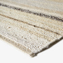 Cream and off-white textured fabric with dark linear elements.