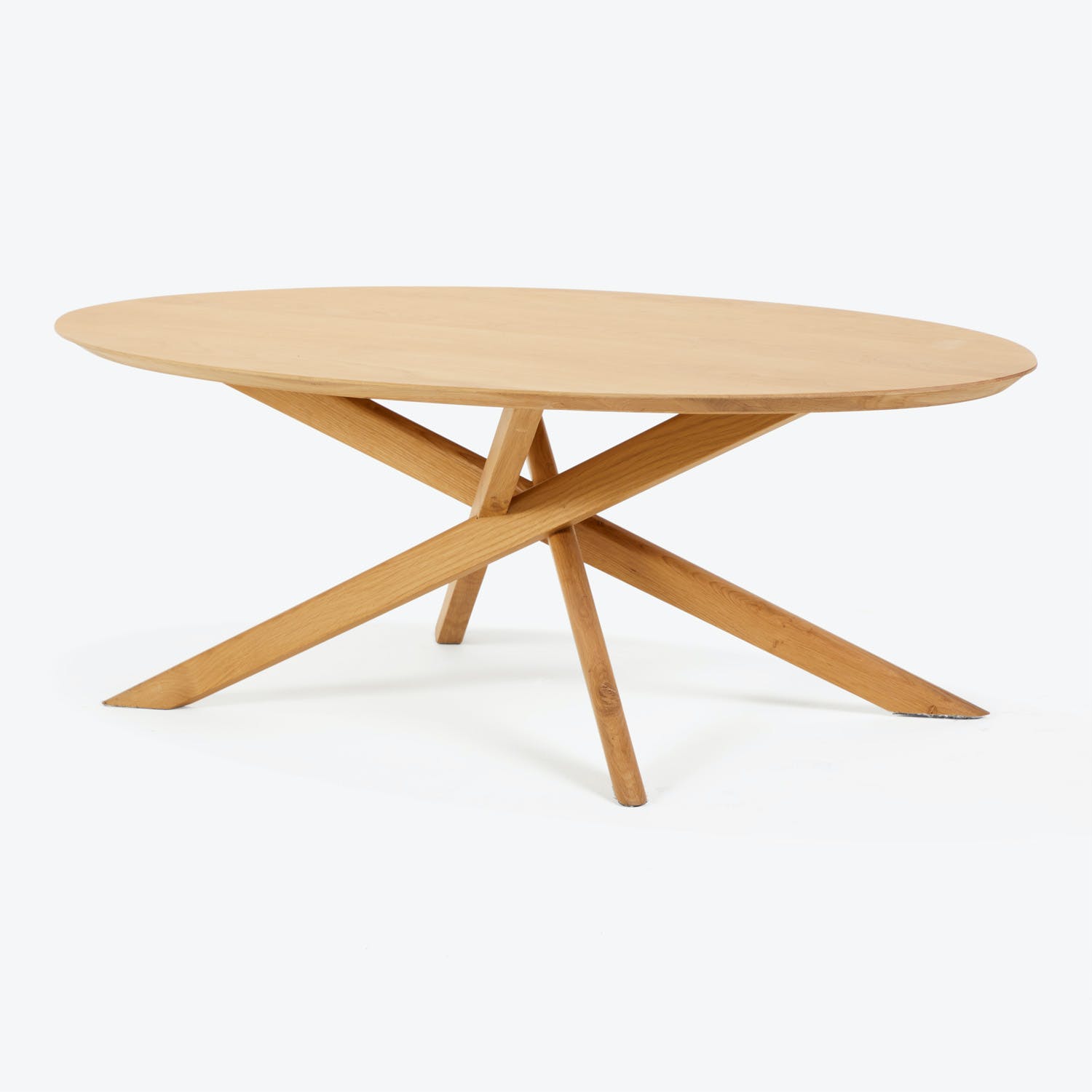 Simplistic modern wooden table with intersecting x-shaped legs on white background.