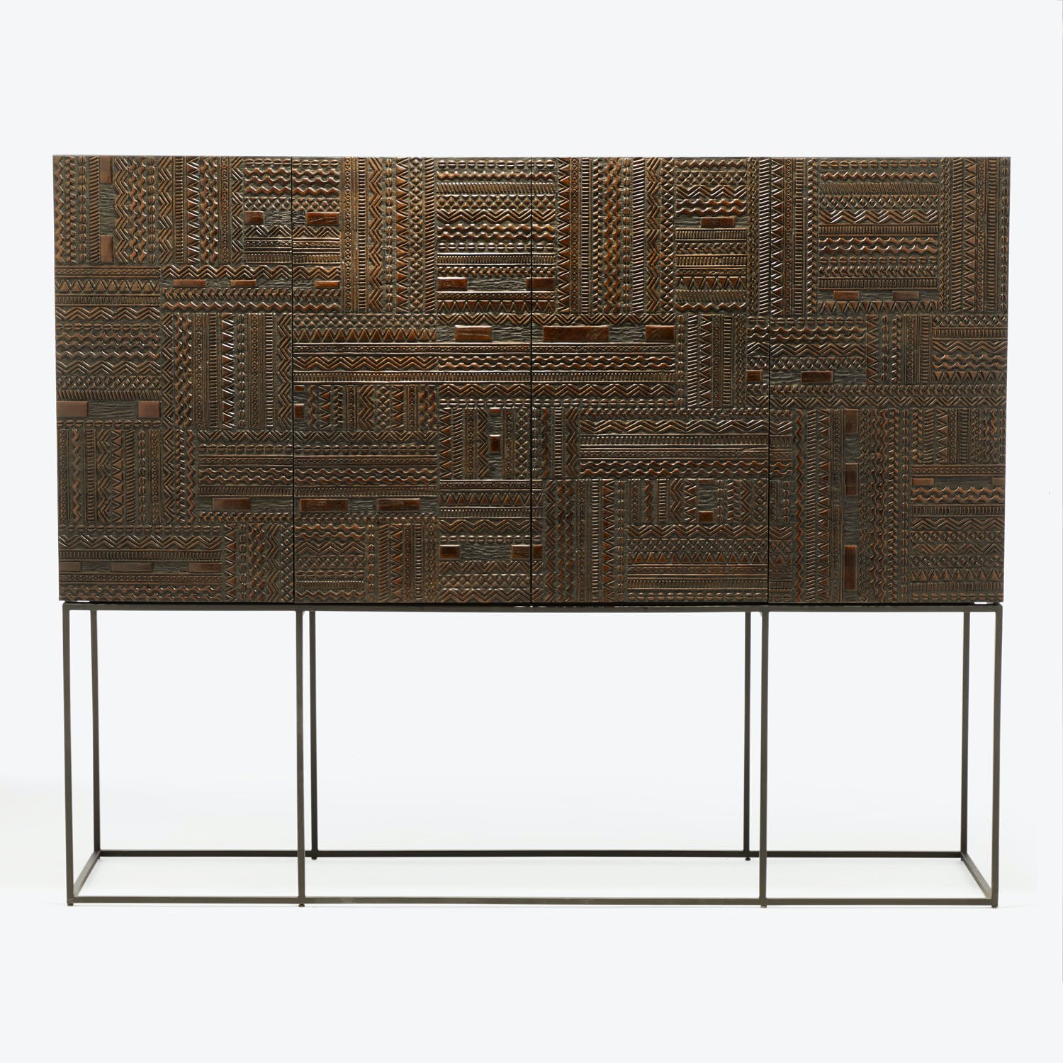 Handcrafted wooden cabinet with geometric textured surface on sleek metal base