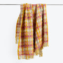 Woven plaid scarf with fringes in vibrant colors and soft texture.