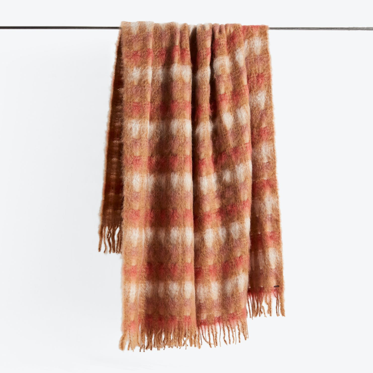Cozy and stylish plaid scarf with fringe detailing on display.