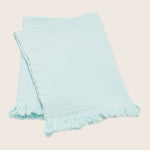 Light blue textile with fringe detail, adding casual decorative touch.
