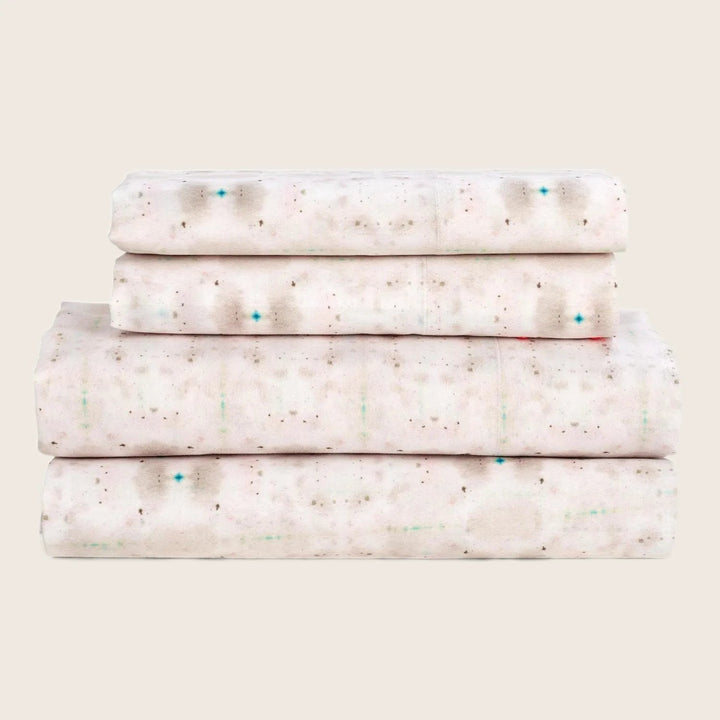 Neatly folded confetti patterned textiles demonstrate tidiness and organization.