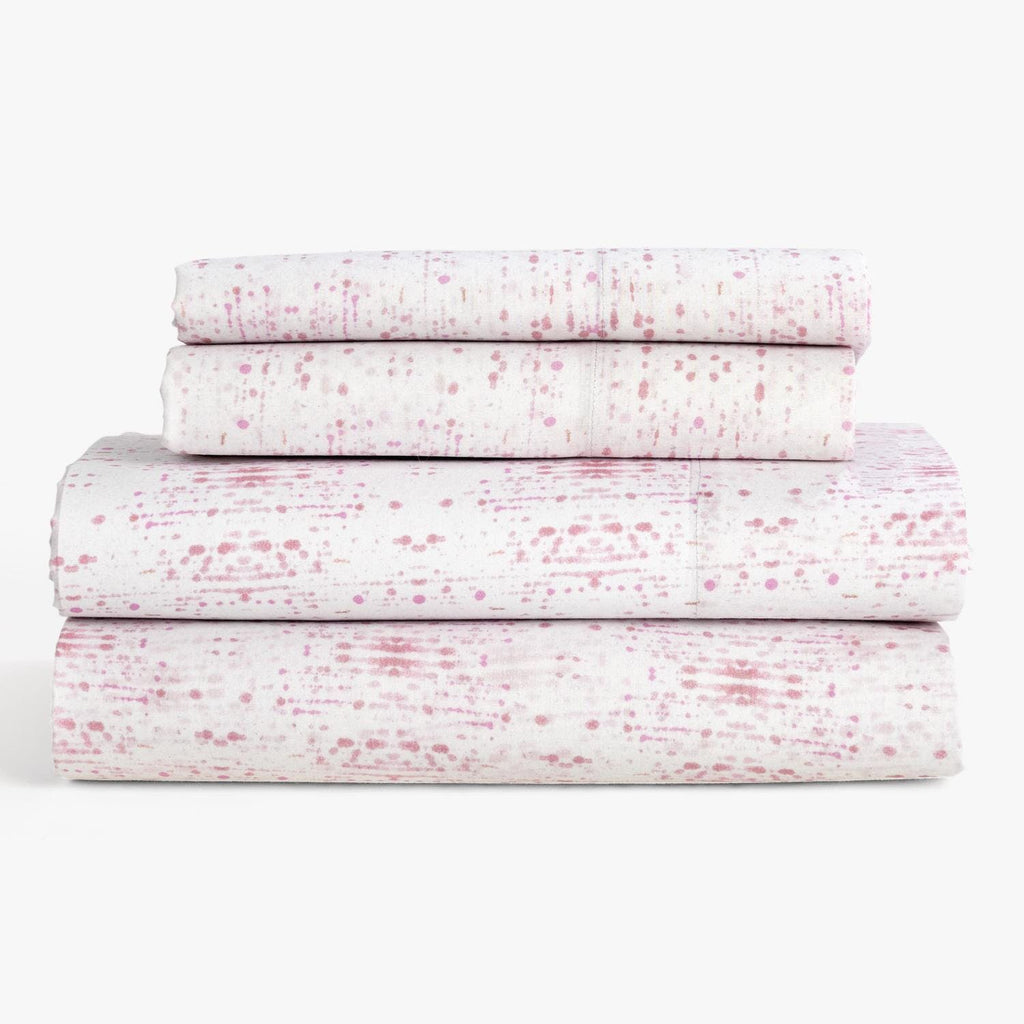 Stacked sheets with modern pink splatter design exude cleanliness and style.