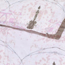 Close-up of pink and gray patterned fabric with visible stains.