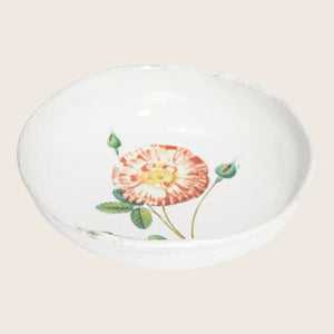 Artisanal ceramic bowl with floral motif showcases rustic charm.