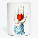 Cylindrical white art object showcases a hand with a heart.