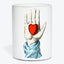 Cylindrical white art object showcases a hand with a heart.