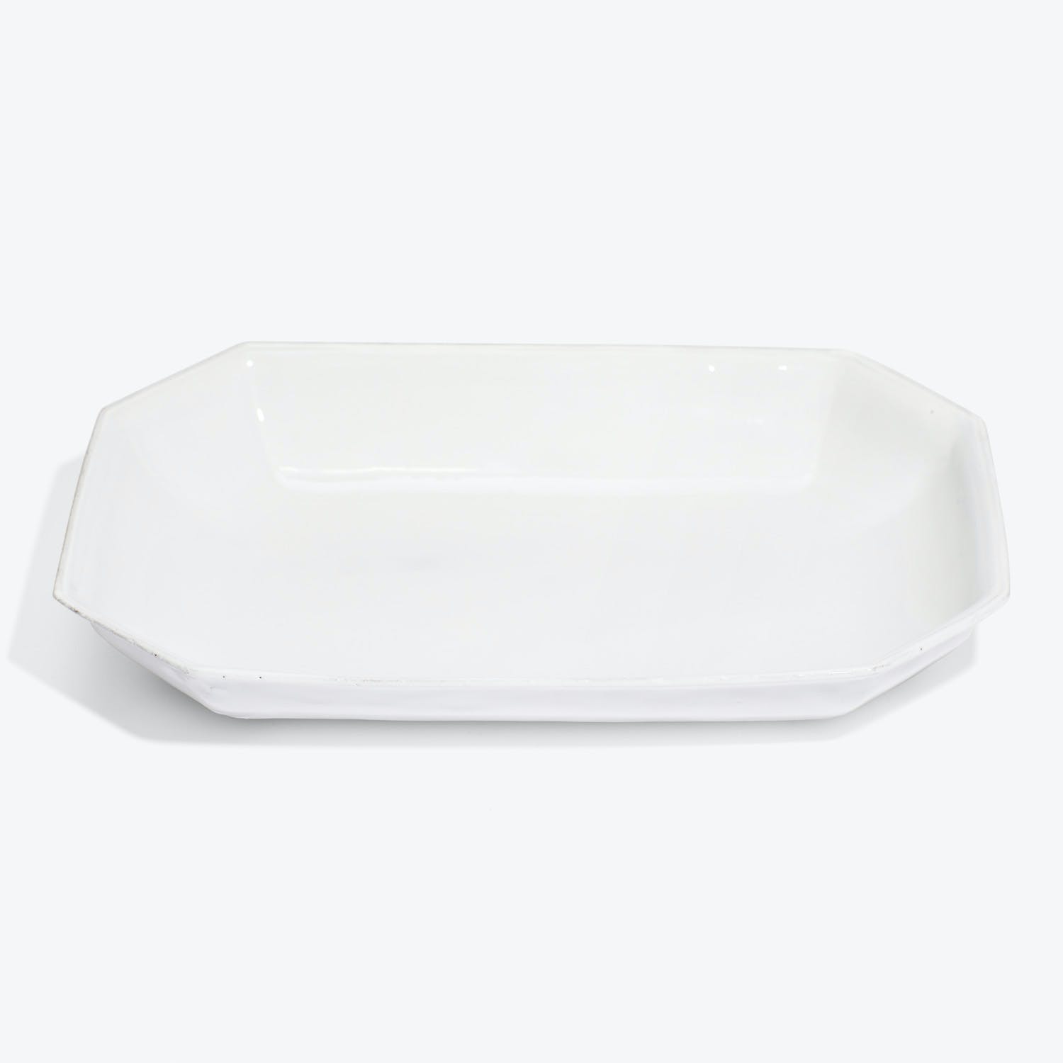 An elegant white octagonal platter with raised edges for serving.