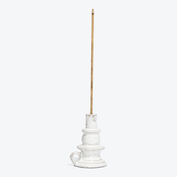 White ceramic candle holder with a brown stick insert.