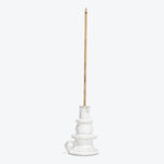 White ceramic candle holder with a brown stick insert.