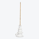 White ceramic candle holder with a brown stick insert.