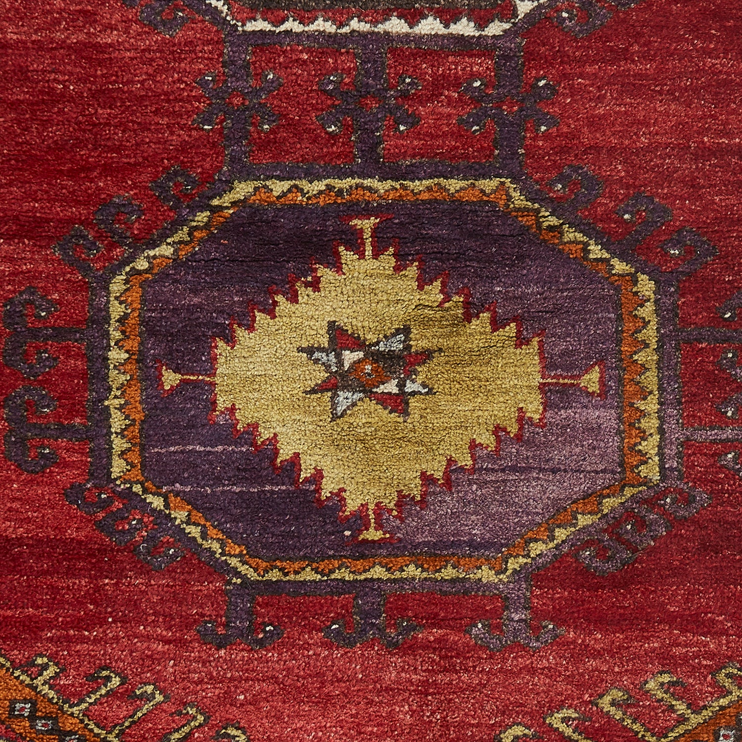 Close-up of a vibrant, intricately patterned traditional hand-woven rug.