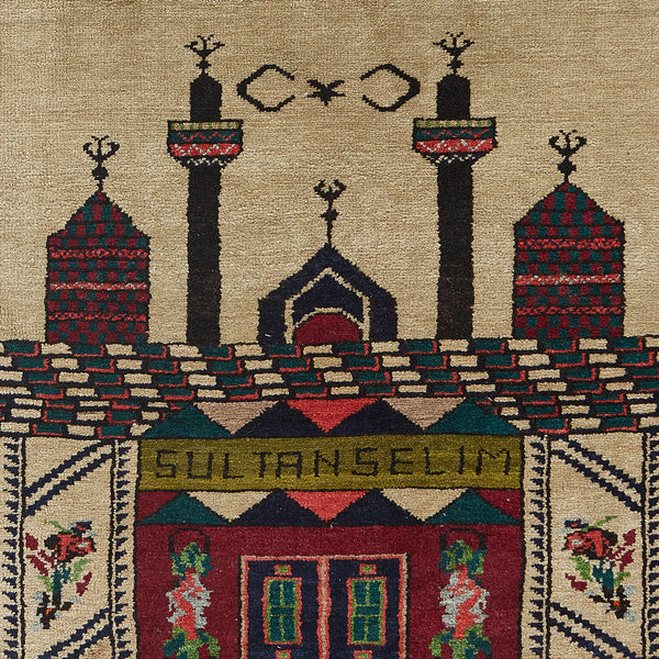 Close-up of handcrafted rug depicting Islamic architecture and intricate patterns
