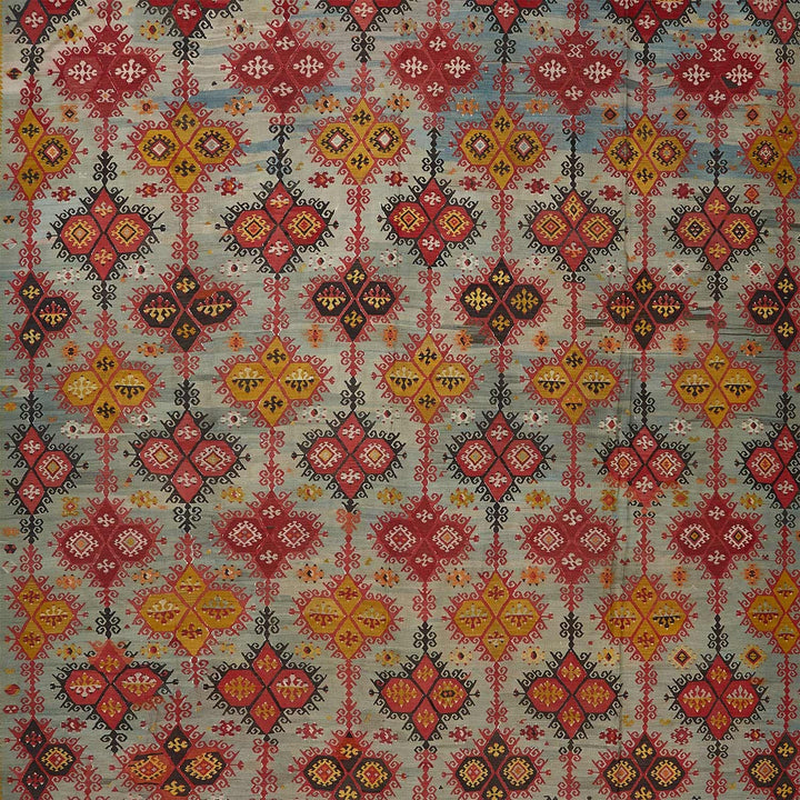 Intricate symmetrical textile design showcasing geometric diamond motifs in vibrant colors.