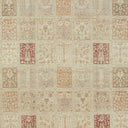 Detailed photograph of a vintage rug with varying motifs and muted colors.