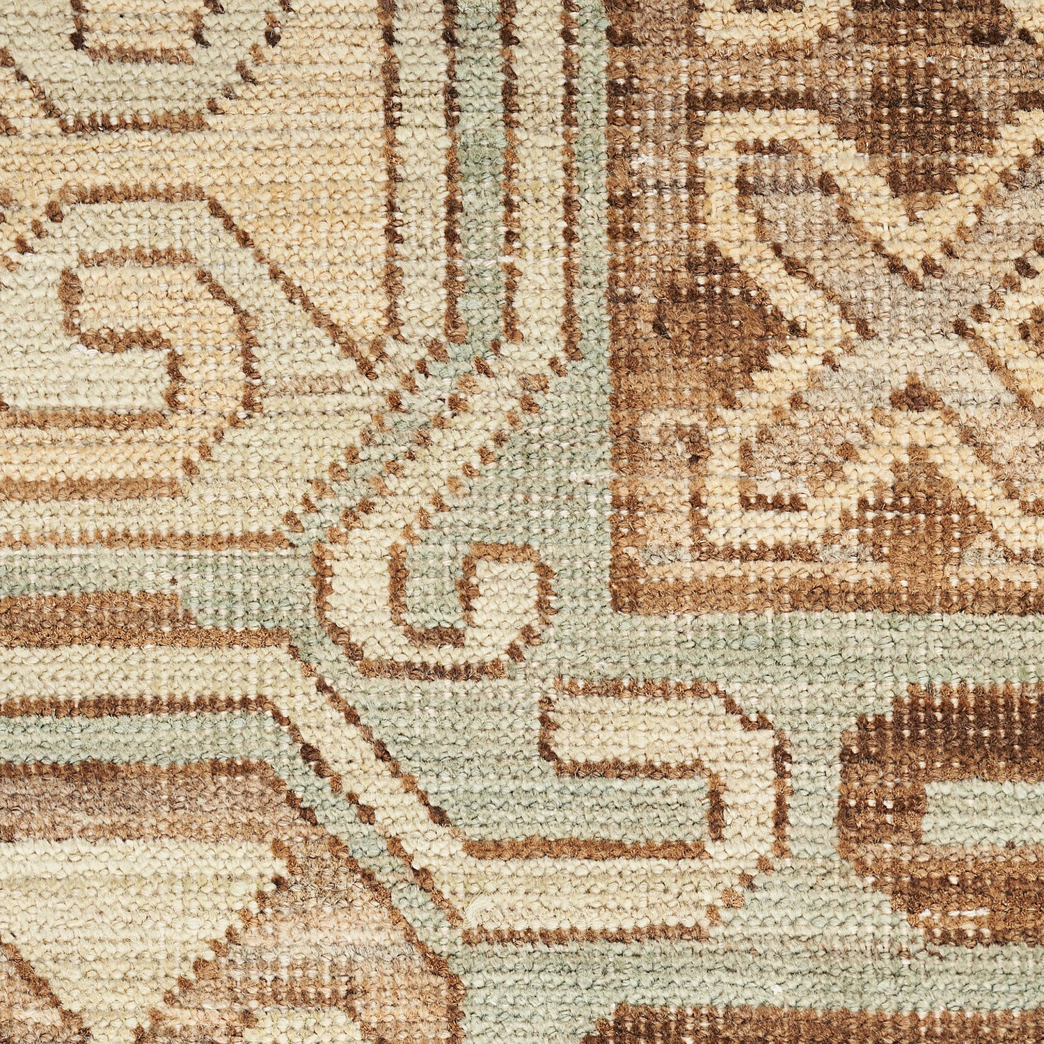 Close-up of a durable woven carpet with intricate geometric designs.