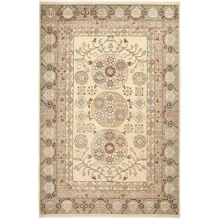 Traditional rug with intricate floral and geometric design in earth tones.